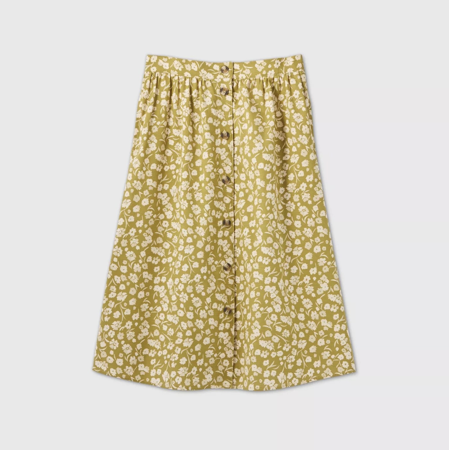 The midi-length, mid-rise yellow/green skirt with buttons down the front and cream flowers on it 