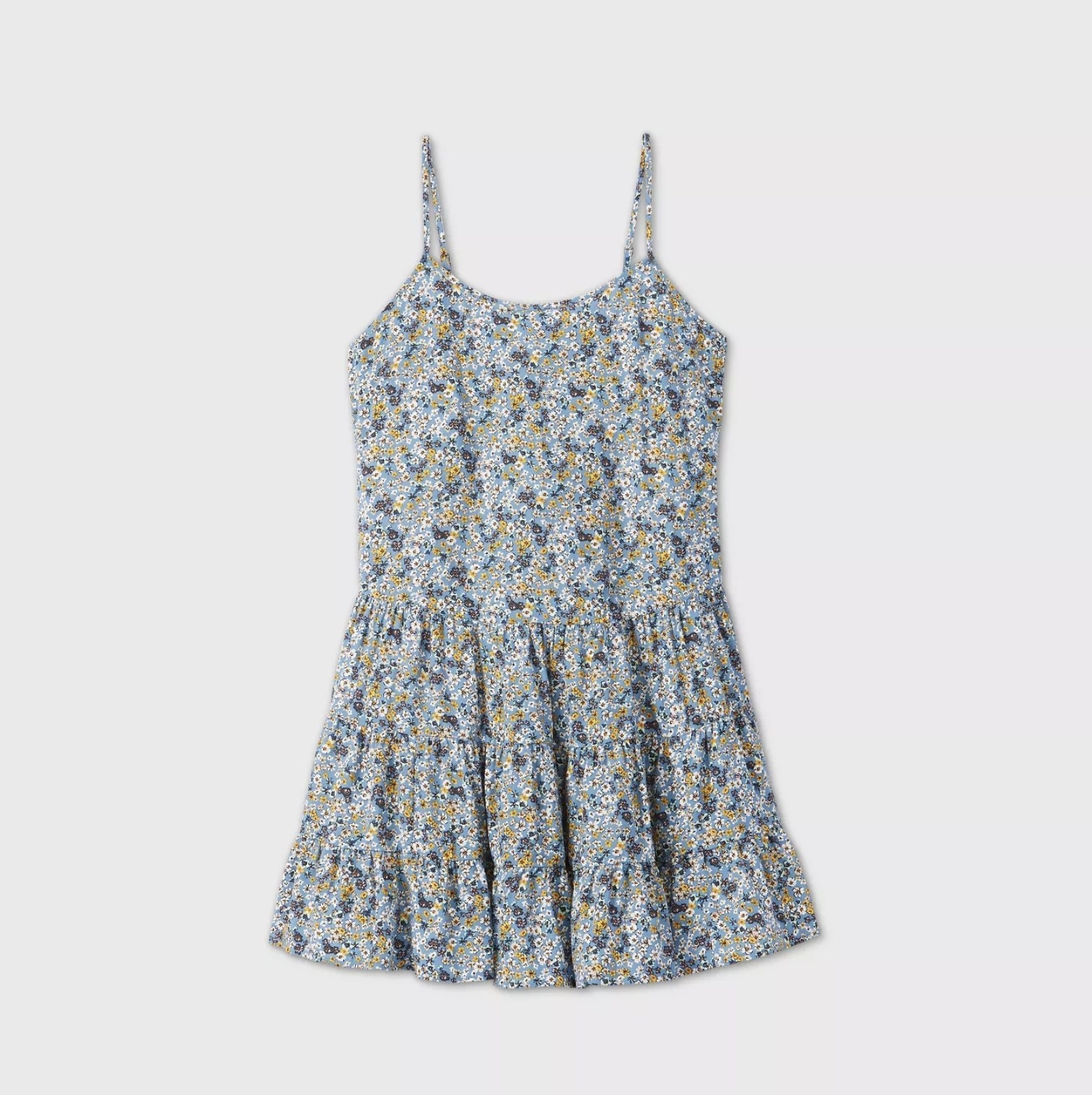 An image of a  light blue floral print trapeze dress with thin shoulder straps and a ruffled drop waist