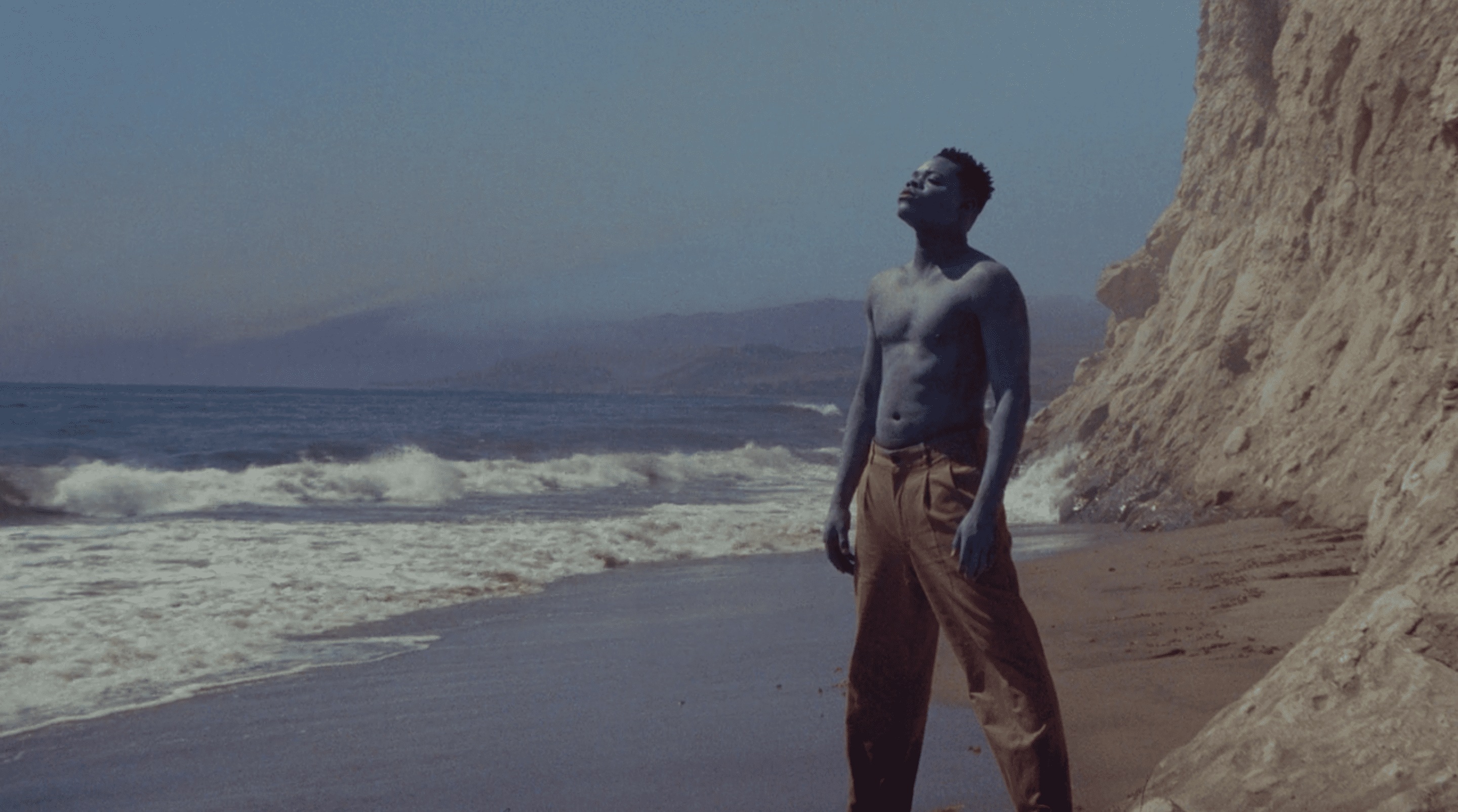 Papi Ojo looks up at the sky as the blue man in &quot;Black Is King&quot;