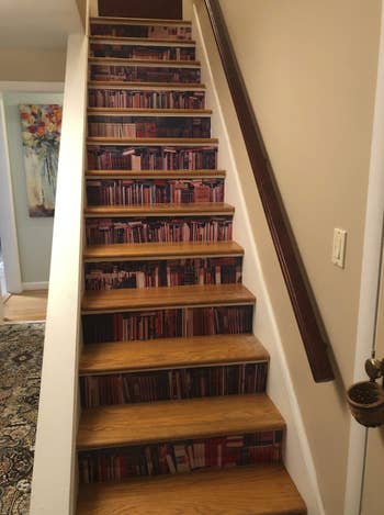 wallpaper on the vertical portion of each step in a staircase. When standing in front of the staircase, all the steps look like books on a bookcase
