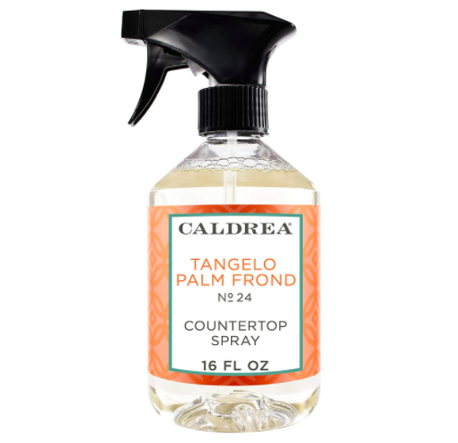 Black and white spray bottle that says &quot;Caldrea Tangelo Palm Frond Countertop Spray&quot; 