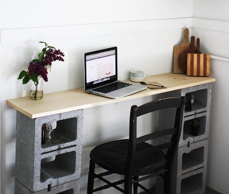 Concrete blocks and a piece of wood stacked into a charming desk