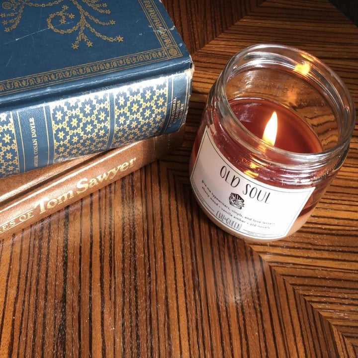 a glass candle that says "old soul" on it