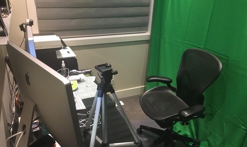 A work station with a hanging green sheet 