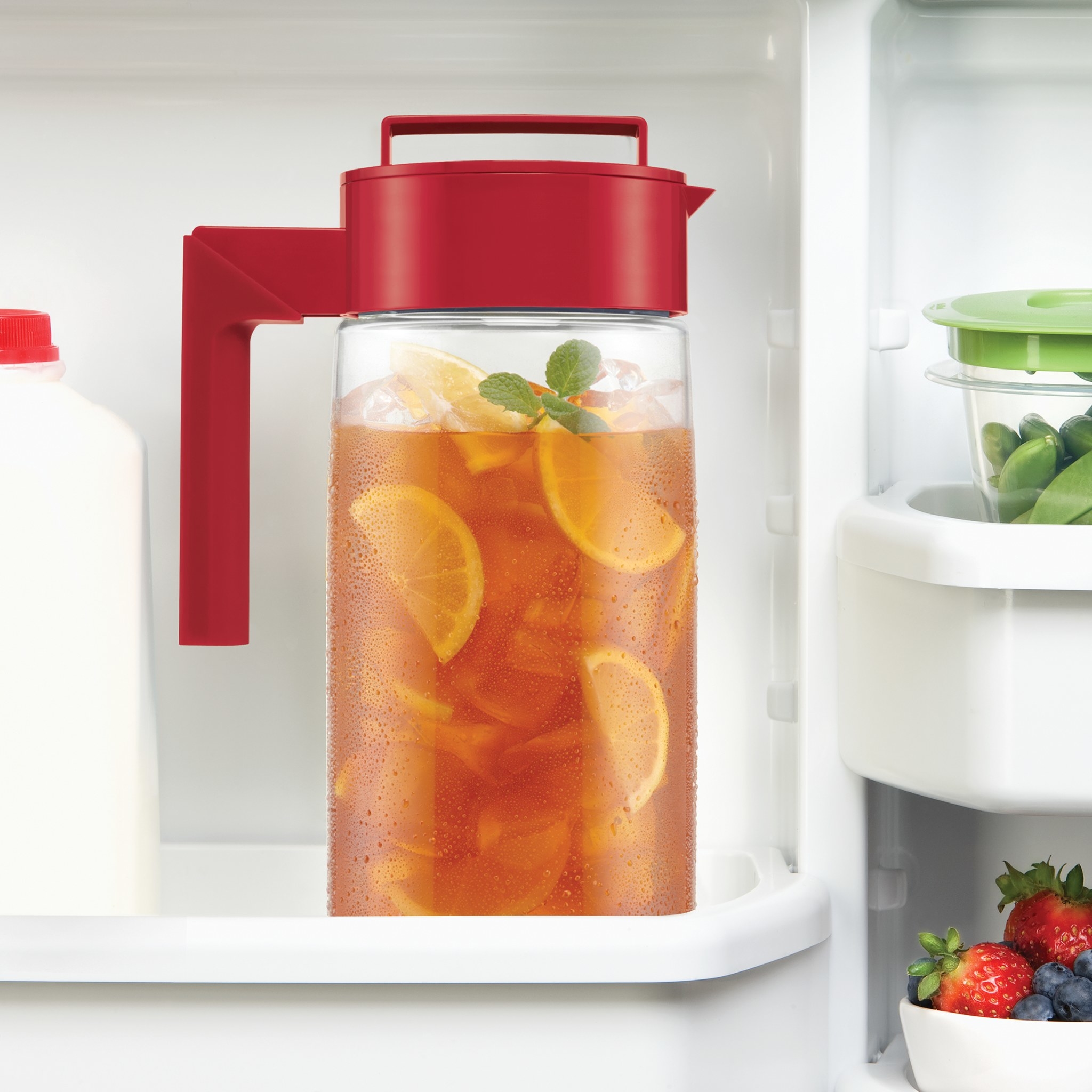 The pitcher, featuring a clear plastic body and red top with handle and pour spout