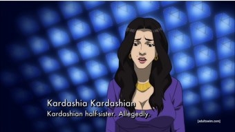 Kardashia has long black hair, a purple dress on, and a big gold necklace. She sits in front of a blue screen. There is a caption that reads &quot;Kardashia Kardashian, Kardashian half-sister, allegedly.&quot;