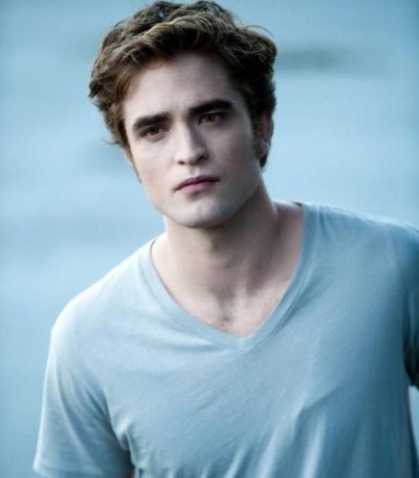 Robert Pattinson as Edward Cullen, wearing a v-neck t-shirt