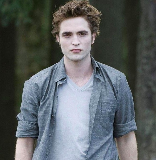 Robert Pattinson as Edward Cullen, wearing a v-neck t-shirt and unbuttoned collared shirt