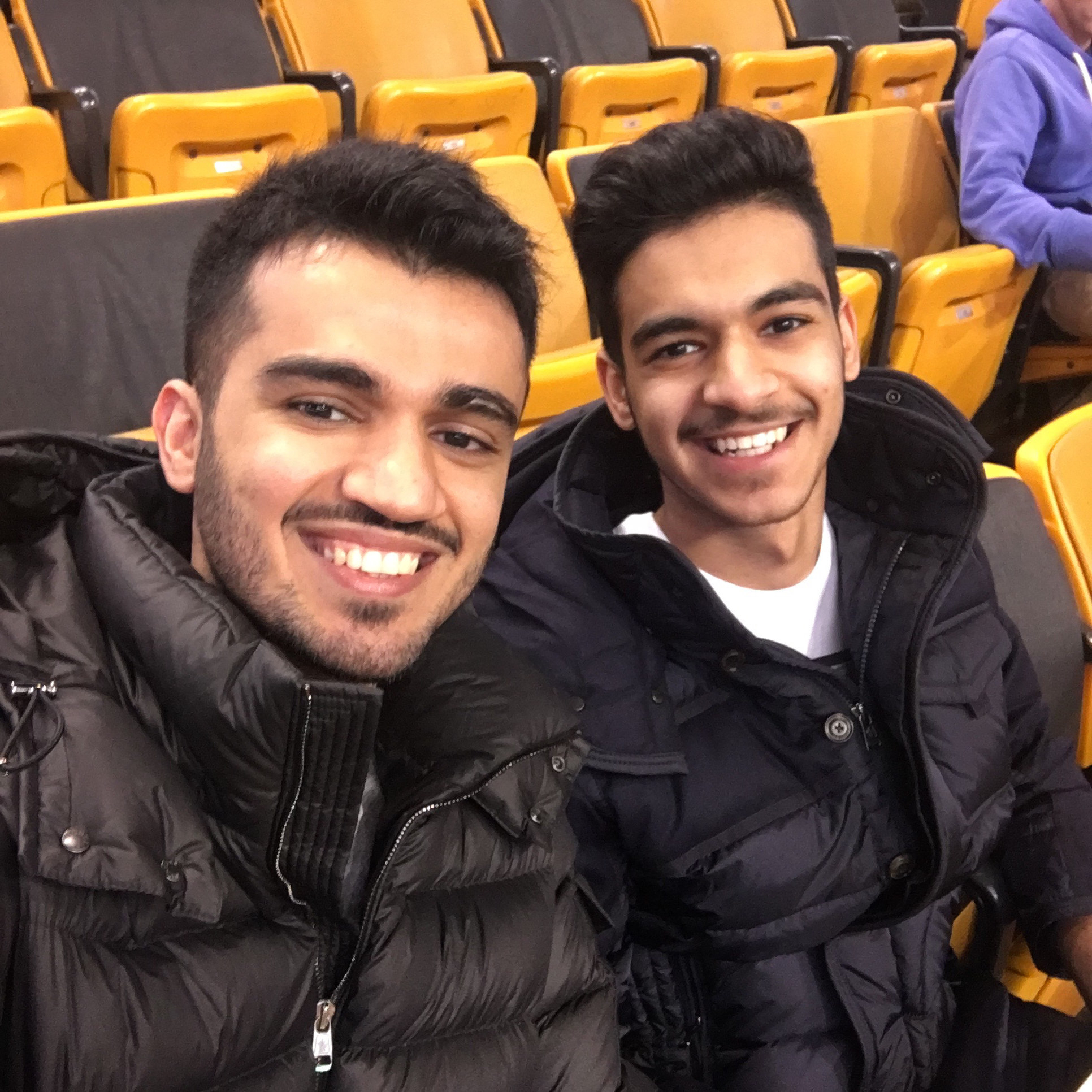 Khalid and Omar Aljabri smile while sitting in a stadium