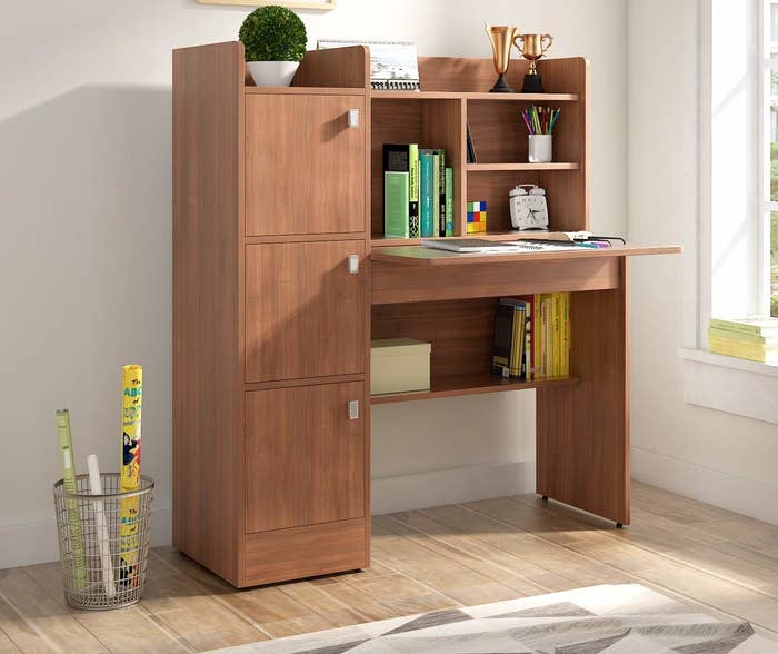 A work desk with cabinets and shelves for extra storage space.