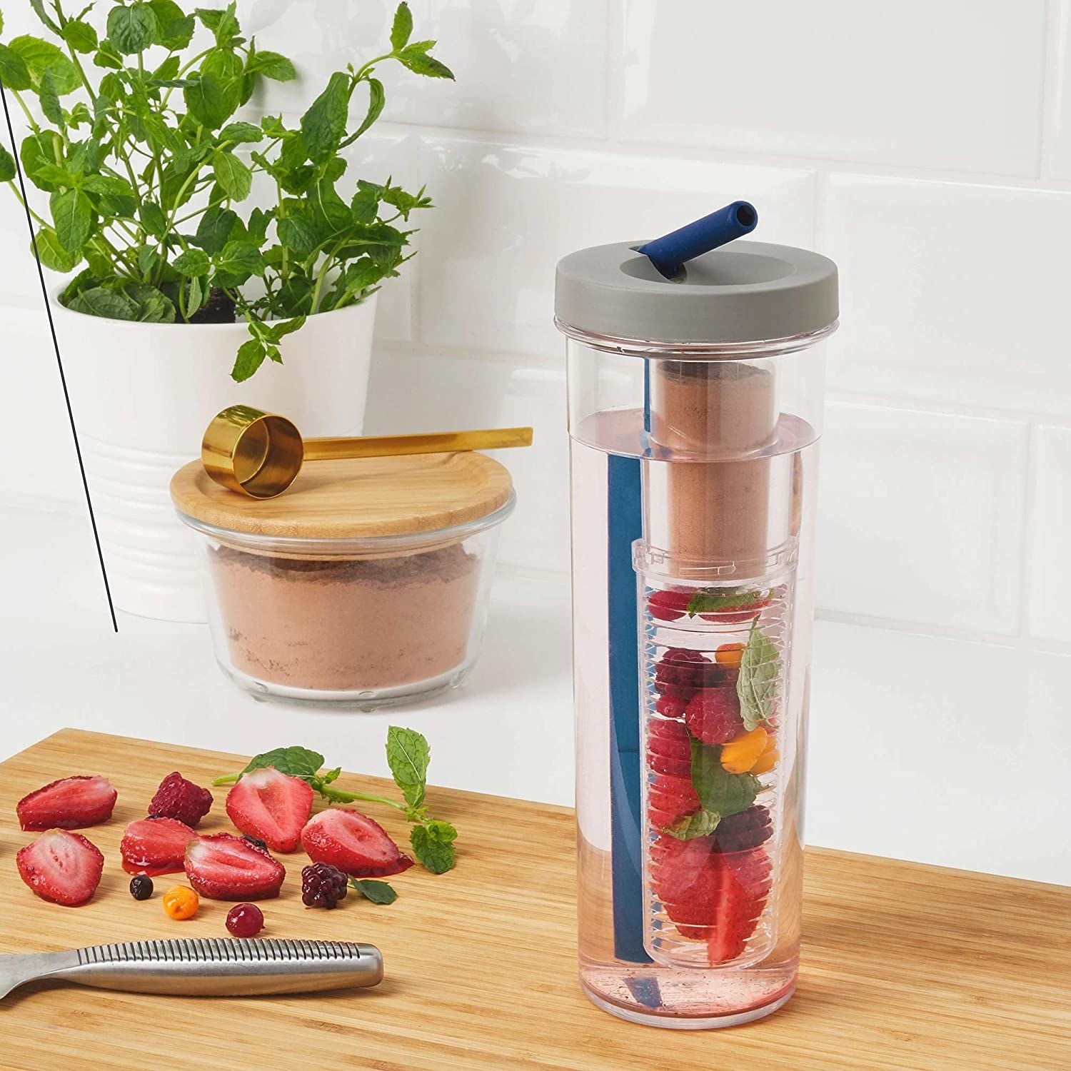The infuser bottle pictured with water and fruits inside it.