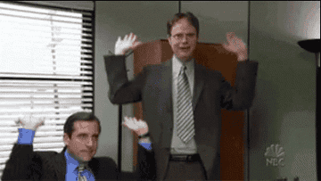 Dwight and Michael from the office making celebratory gestures 