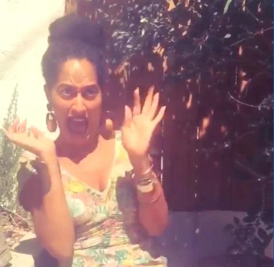 Tracee Ellis Ross screaming with her hands in the air