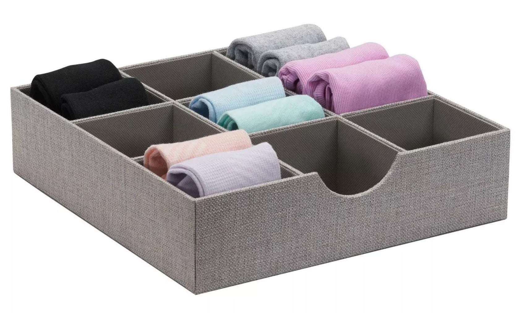 A gray tray divided into nine cubes, five of which are each holding two pairs of socks.