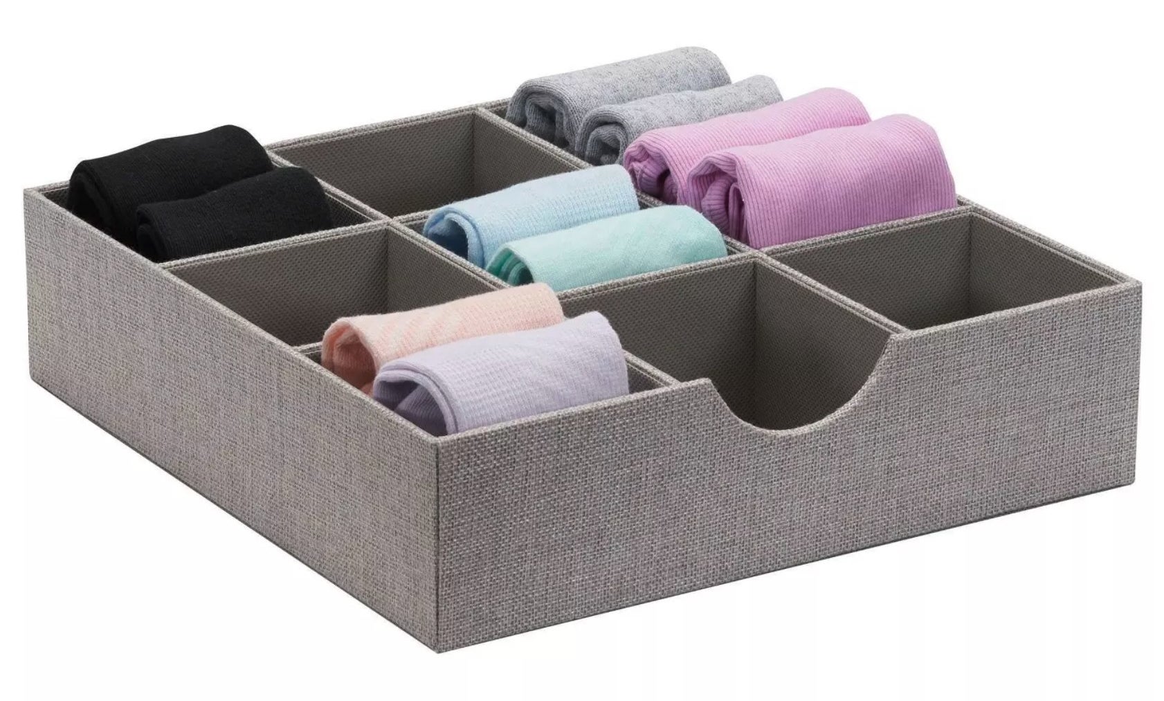 A gray tray divided into nine cubes, five of which are each holding two pairs of socks.