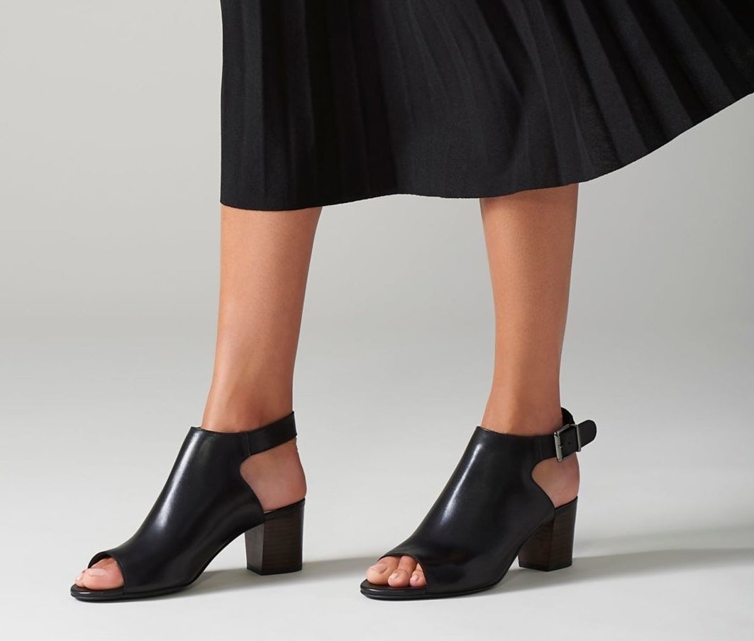 model wearing black open toe heeled sandals