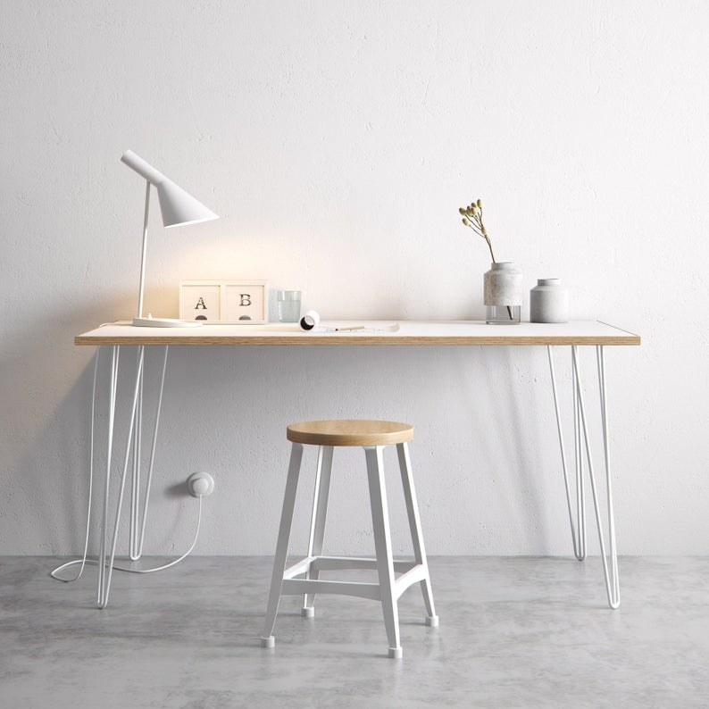 The Scandinavian look white formica coated birch table completed with hairpin legs against a white wall