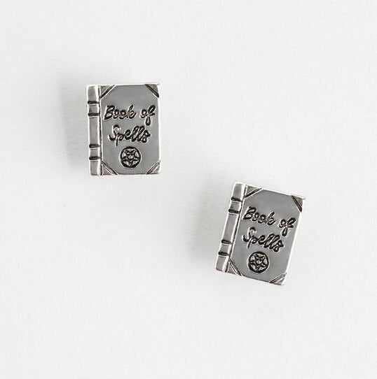 silver book-shaped earrings that say &quot;book of spells&quot; on them