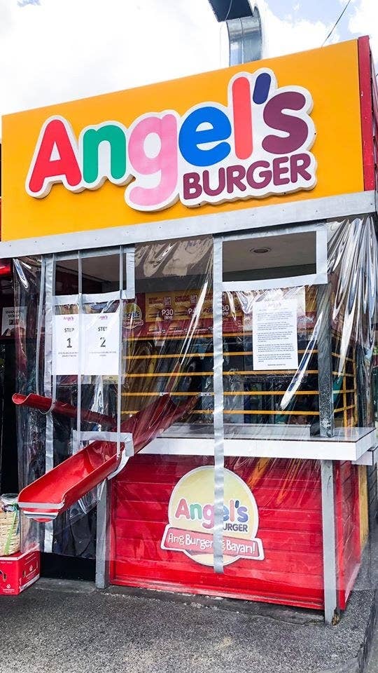 A burger stand with two small ramps leading to and from the counter