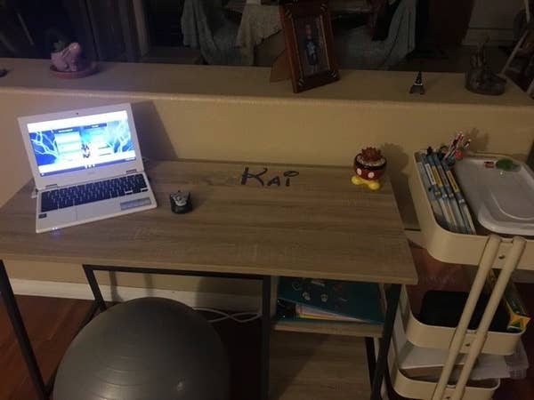 A mom&#x27;s at-home school desk for her son, with a sensory chair and laptop.