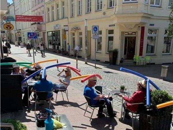 Cafe customers with pool noodles sticking out of their hats