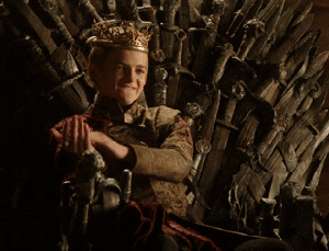 Jack Gleeson as Joffrey sitting on the Iron Throne and clapping in &quot;Game of Thrones&quot;
