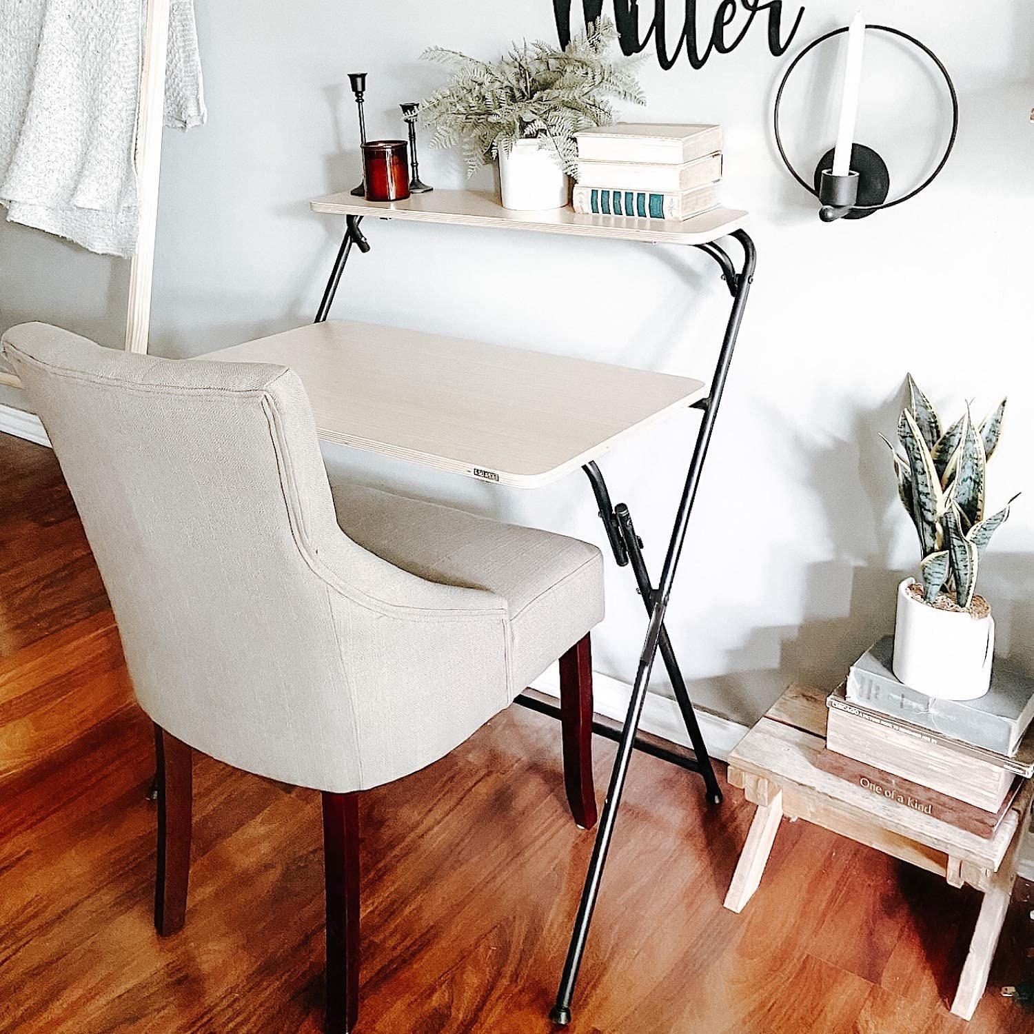 Two-tier wood-top desk with black metal crossing legs