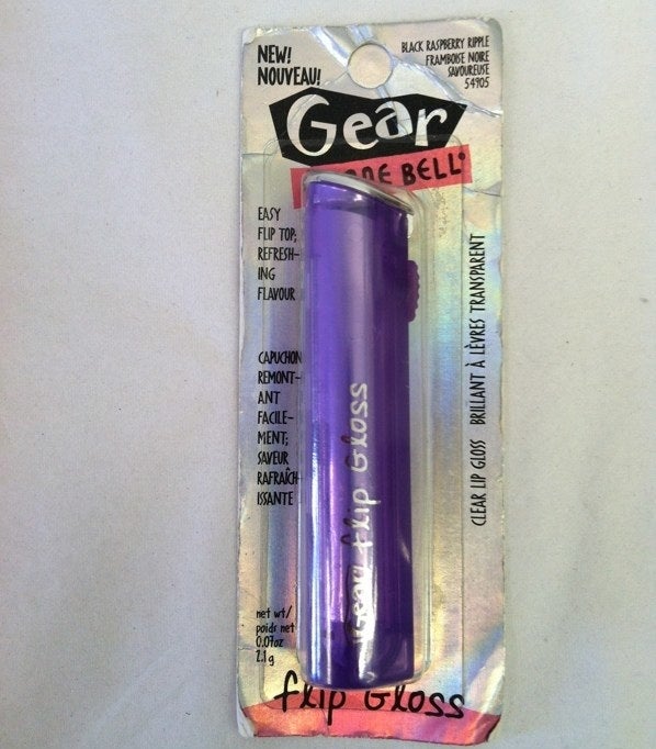 A purple Black Raspberry Ripple-flavored Flip Gloss in its original package