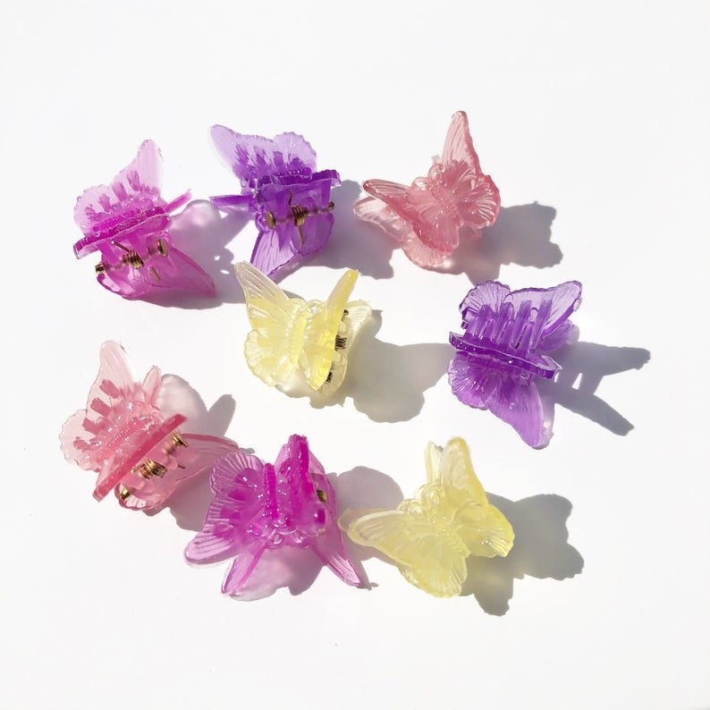 Eight butterfly clips on: two pink, two yellow, two purple, and two hot pink