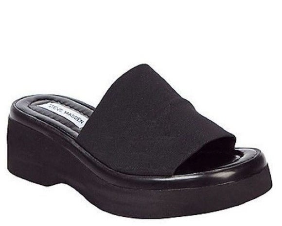 A black platformed Steve Madden slide sandal