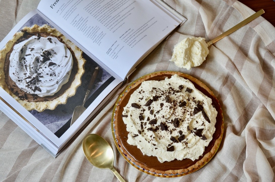 The homemade version of the French Silk Pie next to the recipe and two spoons