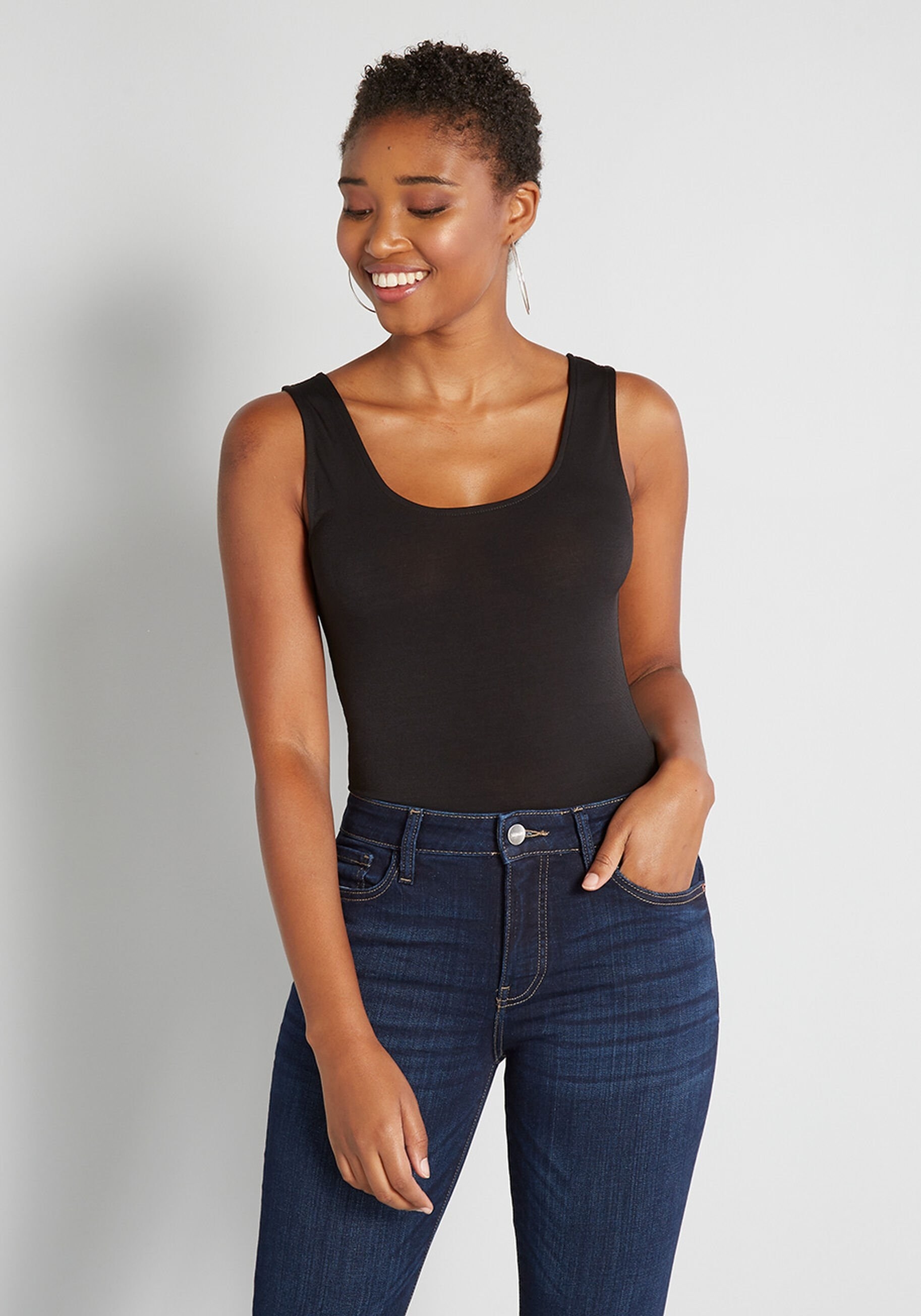 a model in a black bodysuit with jeans