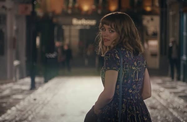 A romantically shot image of Rachel McAdams looking back in the middle of an empty street