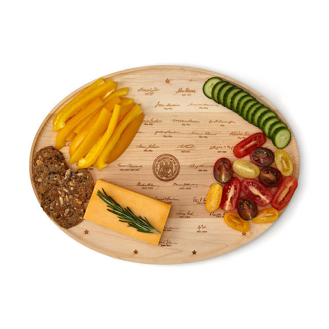 the platter with cheese and various other finger foods on it
