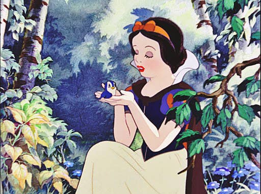 Snow White with rosey cheeks, holding a little blue bird