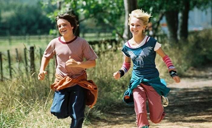 Jess and Leslie running along a dirt road looking happy