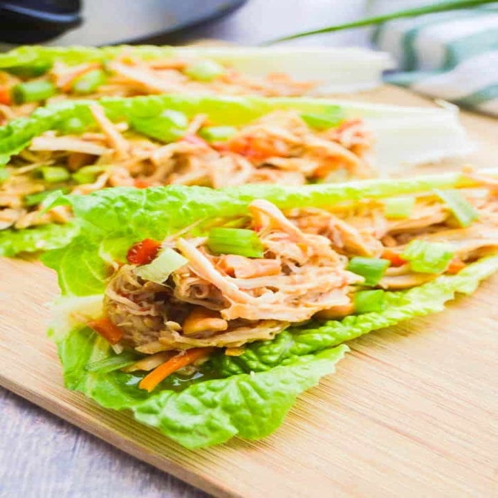 Three pieces of romaine lettuce filled with Chinese shredded cashew chicken.