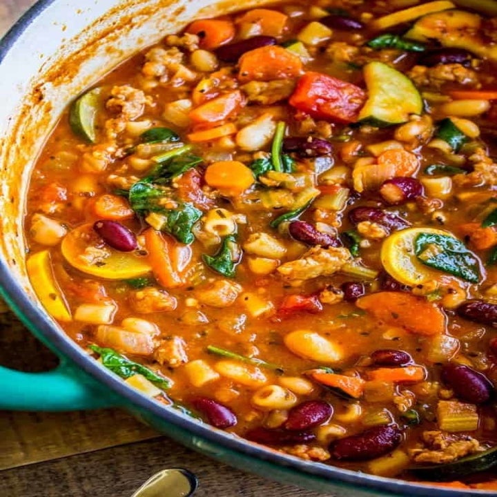 A big pot of Minestrone soup filled with beans and vegetables.