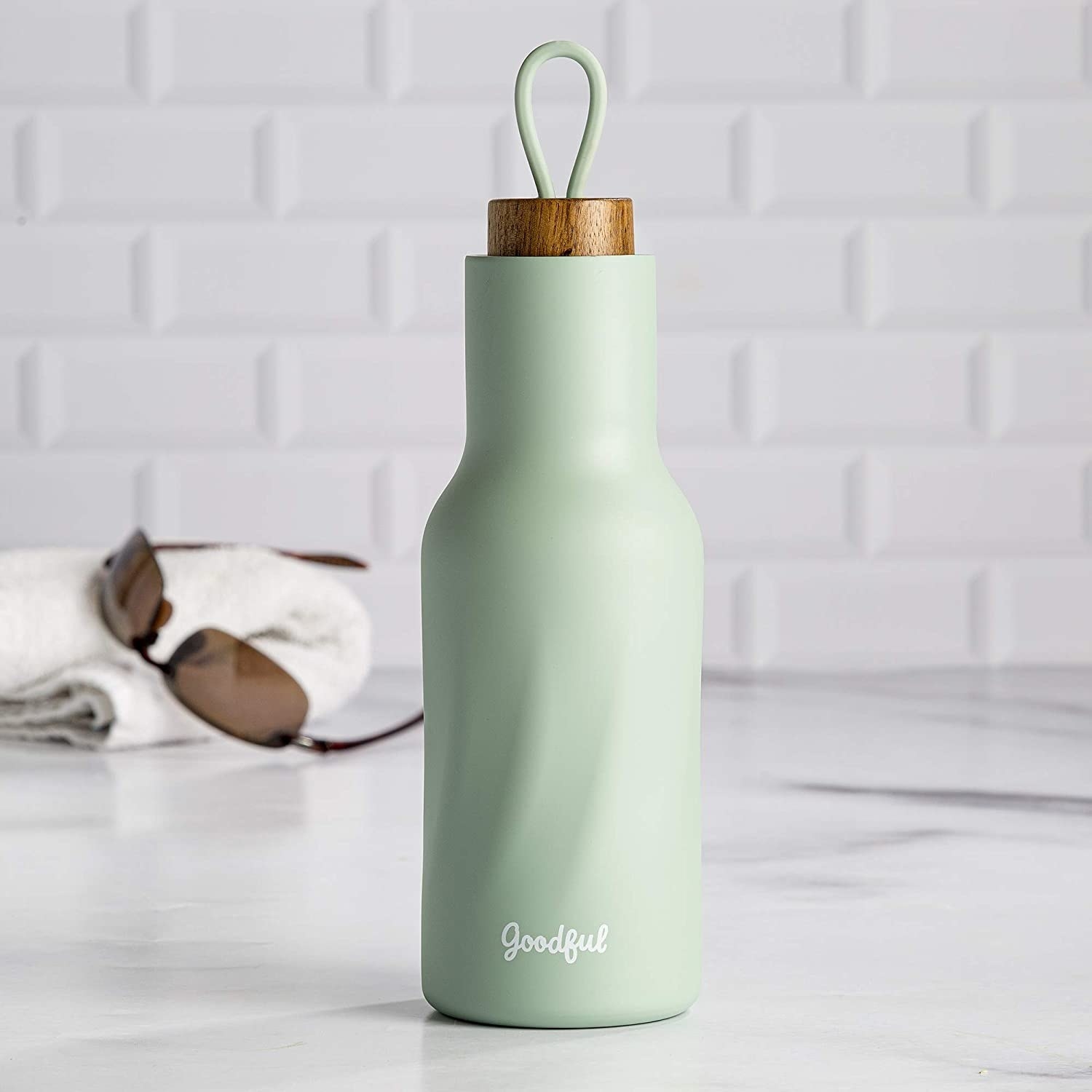 mint green water bottle with faux wood top with a loop