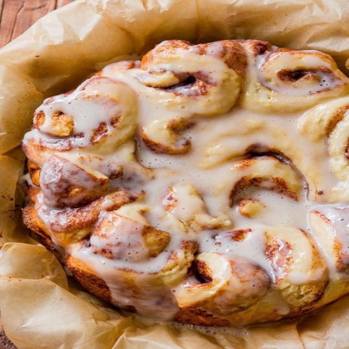 The cooked cinnamon rolls with vanilla icing on top.