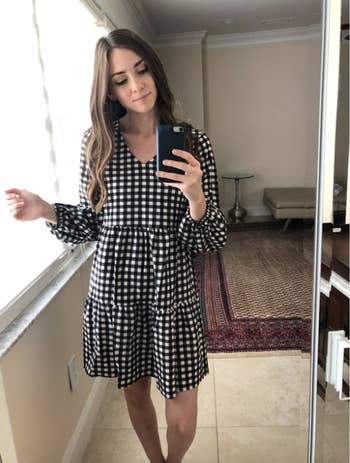 reviewer in the dress in a black and white checkered design