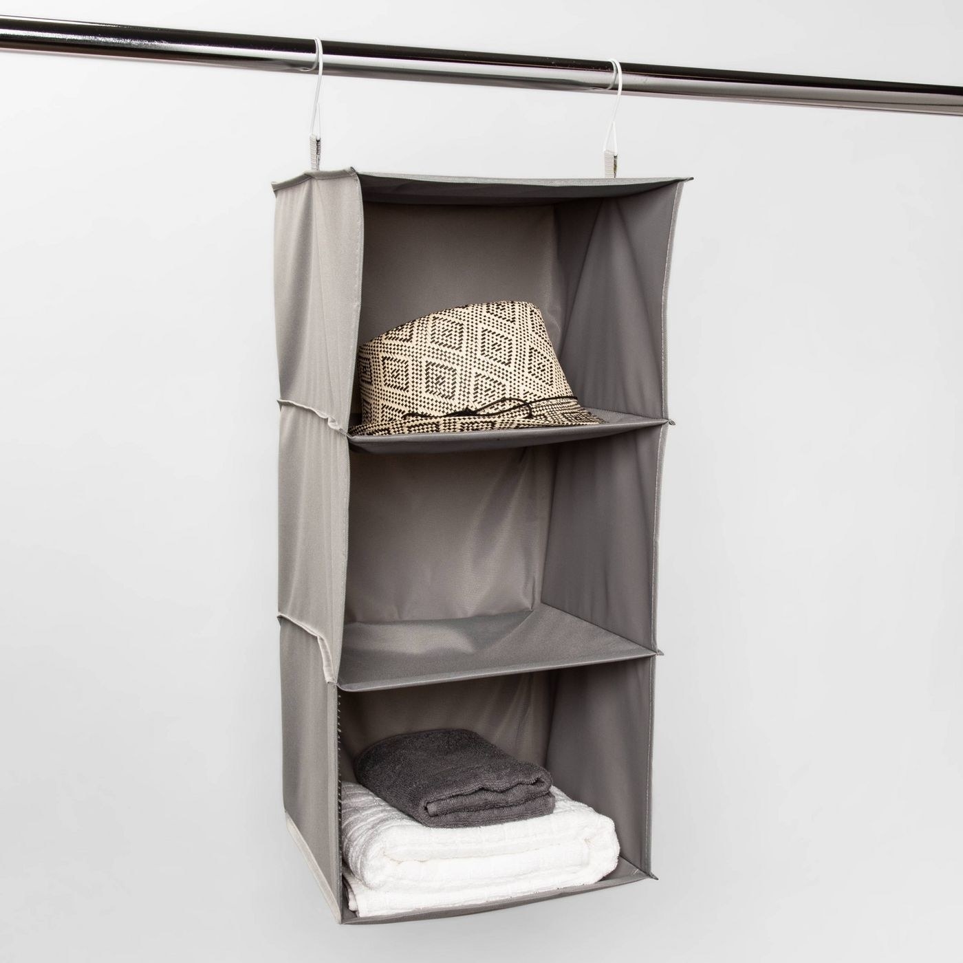 gray closet organizer holding towels and hats