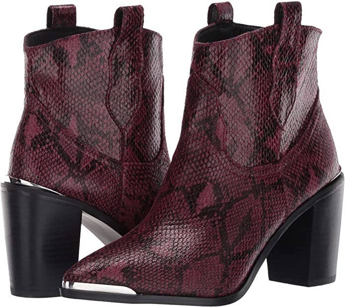 burgundy snakeskin pointedr toe ankle boots with a silver hardware on the toe and a short heel
