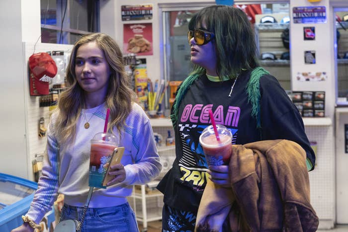 Veronica and Bailey hold slushies in a gas station store