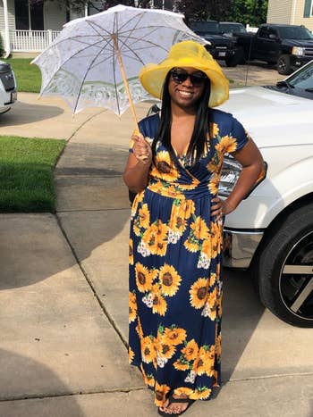 A different reviewer wearing the maxi in navy with yellow sunflowers all over it