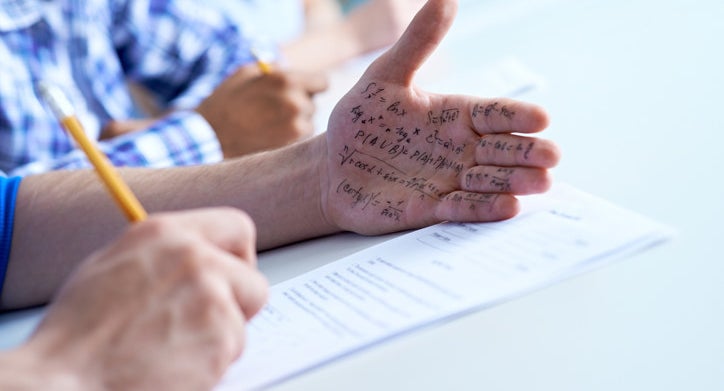 A student uses his palm as a cheat sheet for his test