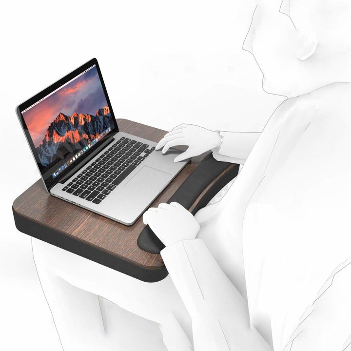 A 3D image of a person using the desk with a laptop on it