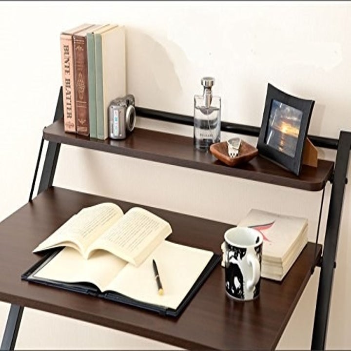 Books on the bottom level and home decor on the top