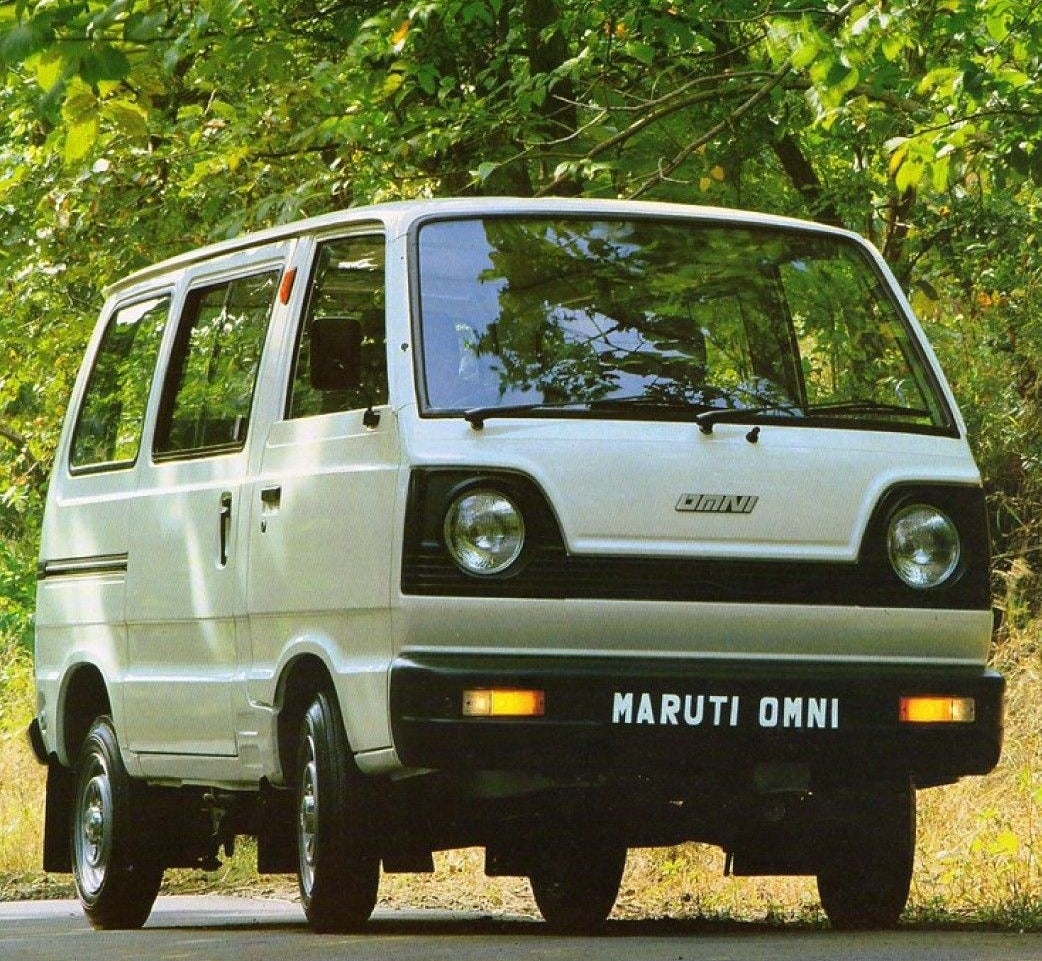 a maruti omni is parked on an empty street