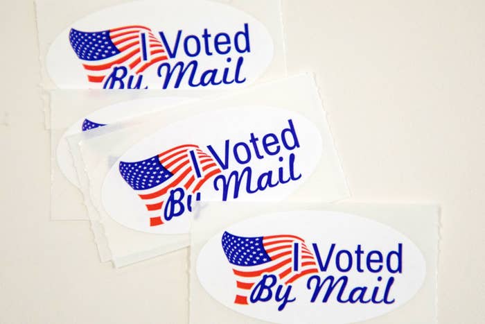 "I Voted By Mail" stickers with American Flags on them